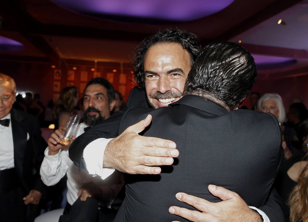 Mexican director Alejandro Gonzalez Inarritu (facing camera), winner for Best Director for 'The Revenant', is embraced upon arrival at the Governors Ball following the 88th Academy Awards in Hollywood, California today. – Reuters pic, February 29, 2016.