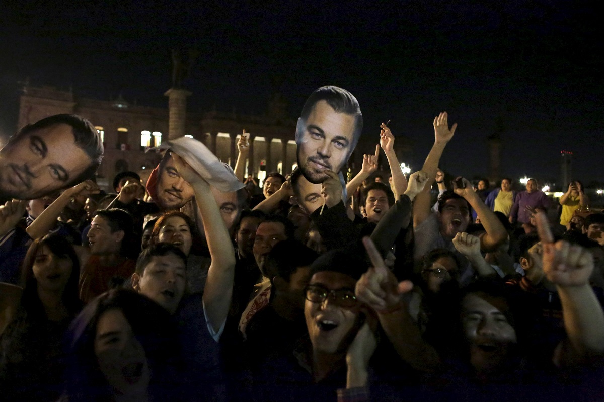 Fans hold images of Leonardo DiCaprio and they celebrate his win for Best Actor in his leading role for the movie 'The Revenant' and Alejandro Inarritu for Best Director for the same film at the 88th Academy Awards in Hollywood, in Monterrey, today. – Reuters pic, February 29, 2016.