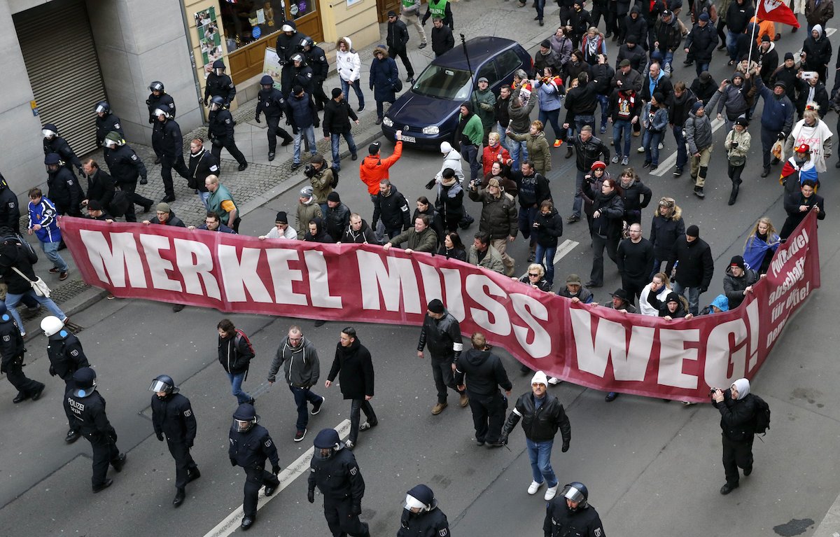 Far right-wing protesters take to the streets yesterday, with a banner reading ‘Merkel Must Go’. Chancellor Angela Merkel has been under increasing pressure after throwing open Germany's doors to newcomers, with 1.1 million refugees seeking asylum in Europe's biggest economy last year alone. –  Reuters pic, March 13, 2016. 