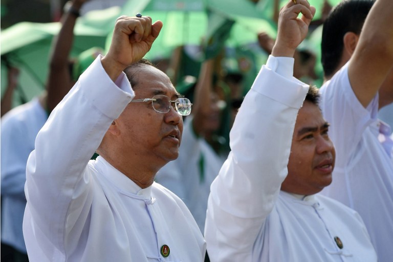 In this picture taken onf October 25, 2015 Yangon chief minister Myint Swe (left) and unidentified official (right) leads campaign rally of the Union Solidarity and Development Party (USDP) in Yangon ahead of the historic November 2015 general elections where the opposition party of Myanmar pro-democracy leader Aung San Suu Kyi won a landslide over the administration military backed USDP. – AFP pic, March 12, 2016.
