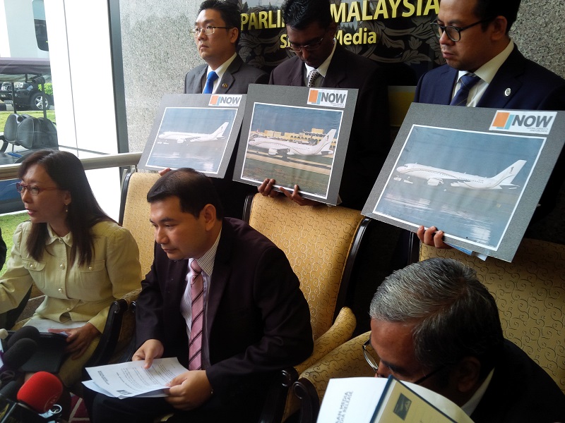 Opposition MPs with photographs of the new private jet ordered for Datuk Seri Najib Razak's use. – The Malaysian Insider pic, March 16, 2015.