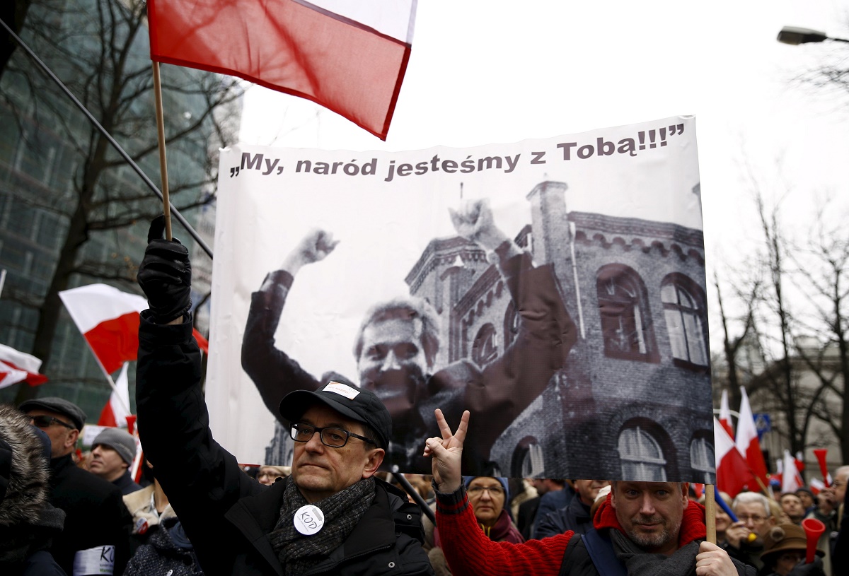 A man holds a banner showing former Polish President Lech Walesa with the slogan 'We, people we are with You!!!' as he takes part in a march demanding their government to respect the country's constitution in front of the Constitutional Court in Warsaw, Poland, yesterday. – Reuters pic, March 13, 2016.