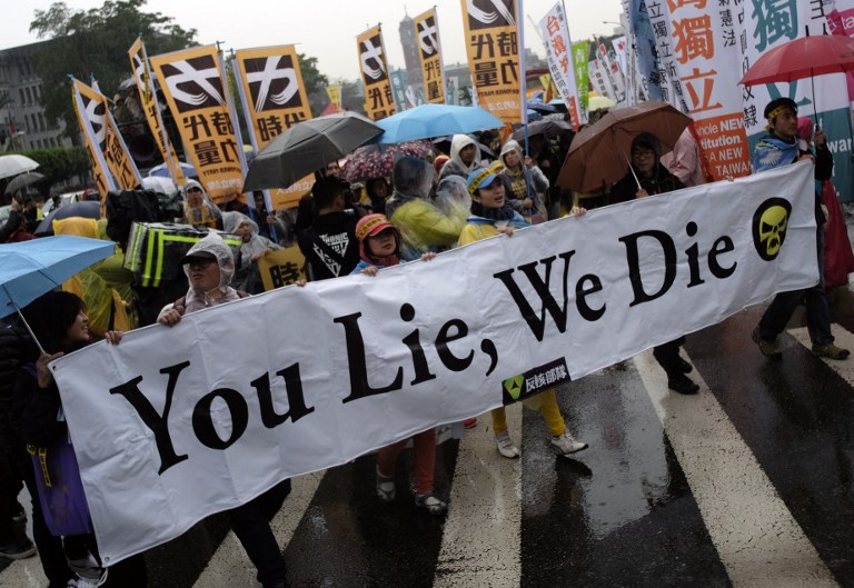Protesters display a banner which reads 'You Lie, We Die' during an anti-nuclear energy demonstration in Taipei today. Hundreds of local anti-nuclear activists took part in an annual protest to demand the government stop to using nuclear power. – AFP pic, March 12, 2016.