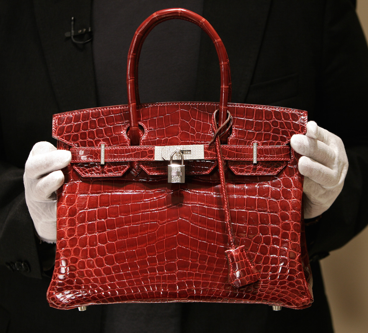 An employee holding a US$129,000 RM491,000) crocodile-skin Hermes ‘Birkin’ bag during a private opening for the new Hermes store on Wall Street. Jane Birkin asked Hermes to rename the mythical crocodile bag series bearing her name, 'until better practices that meet international standards’ are in place for the slaughter of these animals. – AFP pic, July 29, 2015.