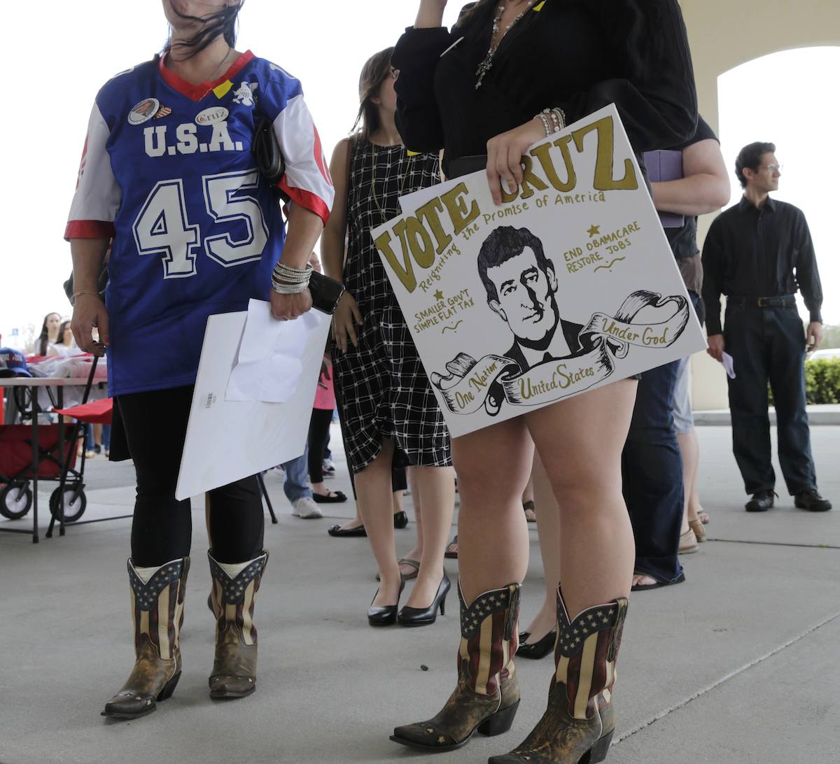 Cruz supporters Michelle Yoxtheimer and Maggie Yoxtheimer from Palatka, Florida carry homemade signs and wear flag-themed cowboy boats as they wait to see a Republican US presidential candidate Ted Cruz town hall campaign event. After the win in Wyoming, Cruz hopes to win over delegates in Florida. –  Reuters pic, March 13, 2016. 
