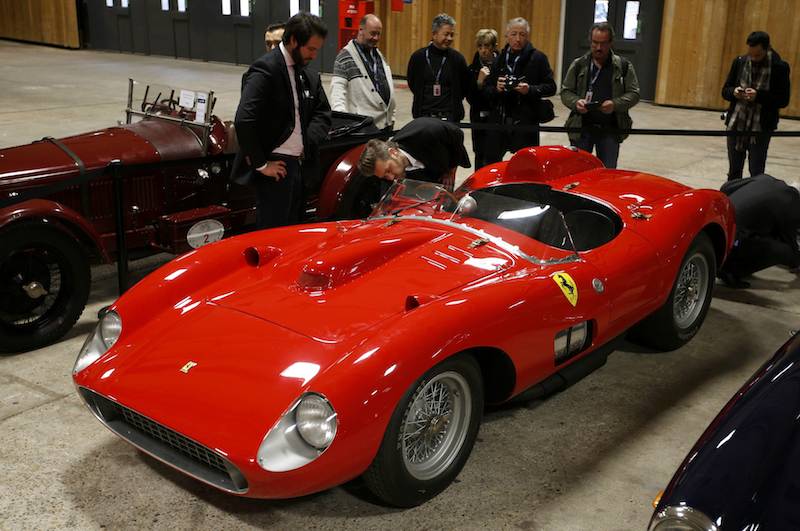 Visitors look at a red 1957 Ferrari 335 Sport Scaglietti on display at the Paris Retromobile fair in Paris, France, yesterday. The vehicle is one of the most iconic racing cars in the history of the sport. – Reuters pic, February 6, 2016.