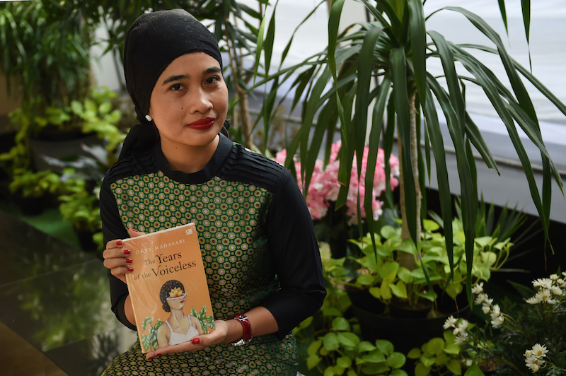 Indonesian author Okky Madasari poses with her book 'The Years of the Voiceless', an English translation of her book 'Entrok', in Jakarta. Indonesia is the guest of honour at this year's Frankfurt Book Fair, the industry's biggest annual get-together for publishers, editors and writers from around the globe. – AFP/Relaxnews pic, October 14, 2015.