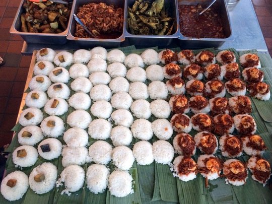 The rows and rows of nasi lemaks waiting to be wrapped up are just challenging us to eat them all up. — Pic courtesy of HungryGoWhere, May 18, 2015.