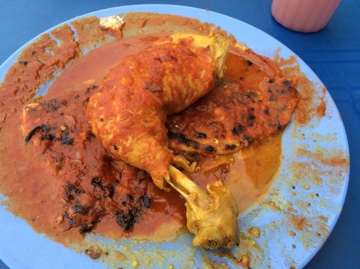 Just when you think roti canai can't get any better, just banjir it and slap a juicy piece of chicken on top! — Pic courtesy of HungryGoWhere, May 18, 2015.