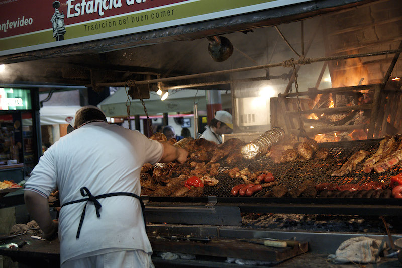A cook tends to the barbecue at the old Port Market in Montevideo. Without meat on the menu every day, 'Uruguay would not exist', some diners say. – AFP/Relaxnews pic, November 2, 2015.